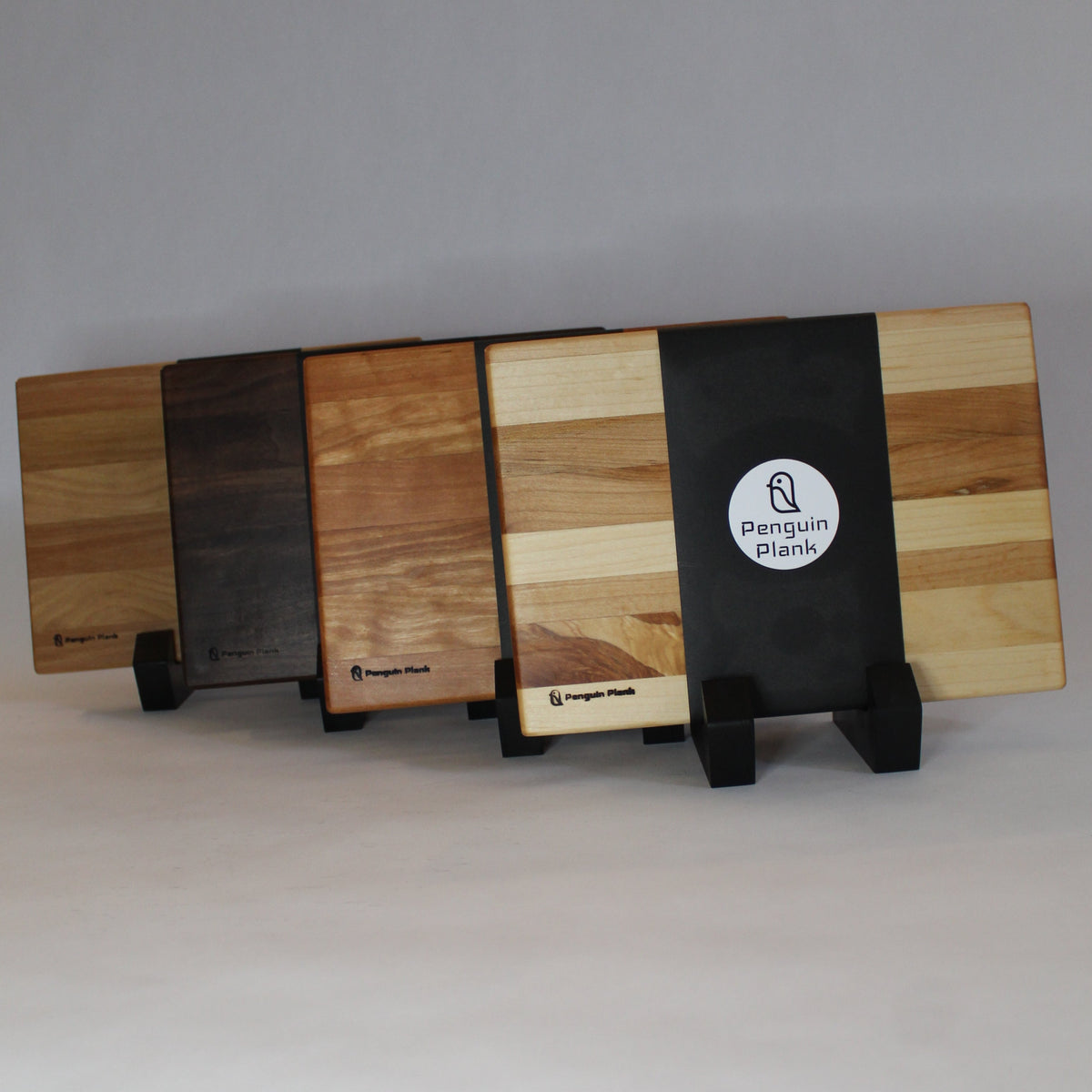 Walnut cheese board with penguin handle for outdoor picnics and entertaining.