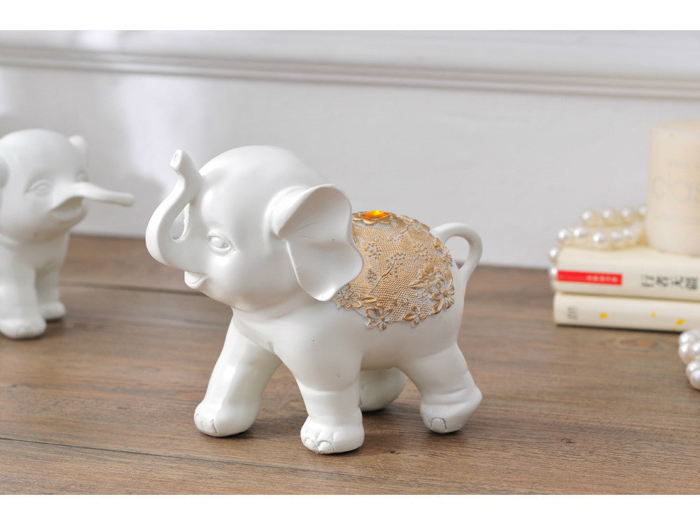 White resin elephant family sculpture for home decor.