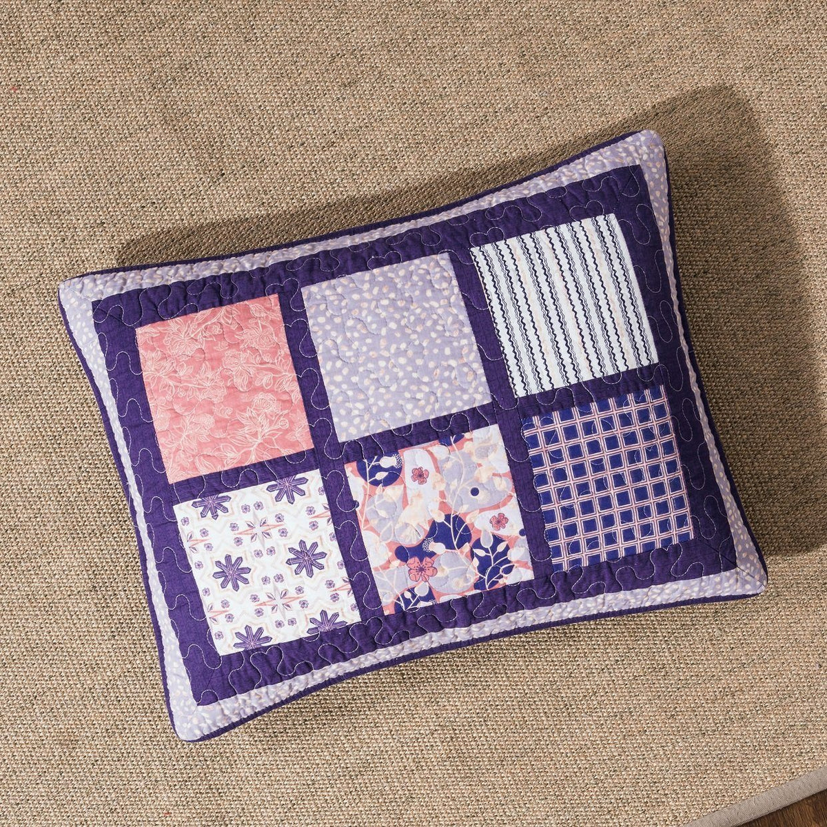 Peachy pink, plum purple floral patchwork quilted bedspread set detail.