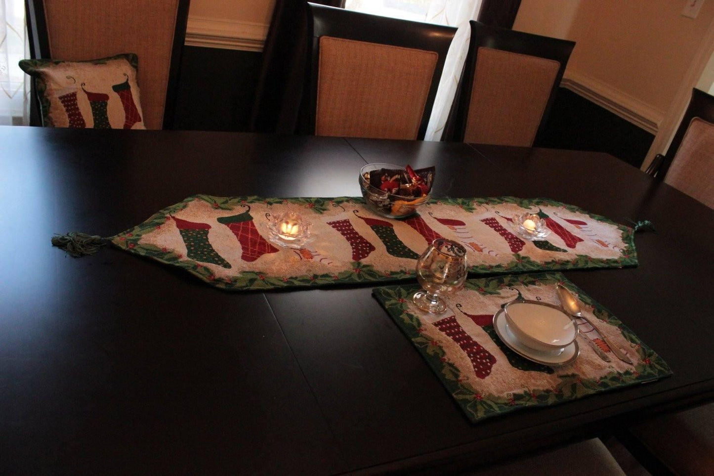 Christmas table runner with stockings and fireplace decor wall hanging.