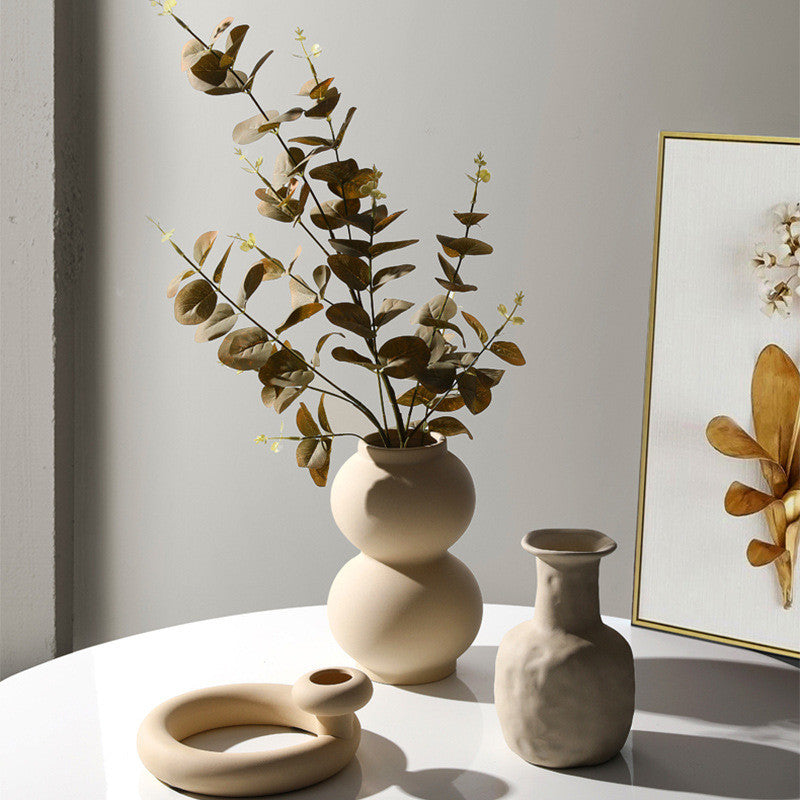 Taupe ceramic vase set with modern minimalist candle holders.