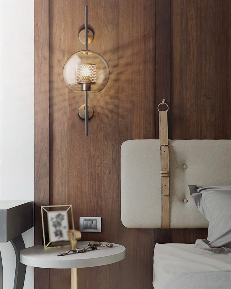 Retro industrial glass ball wall sconce with bronze finish.