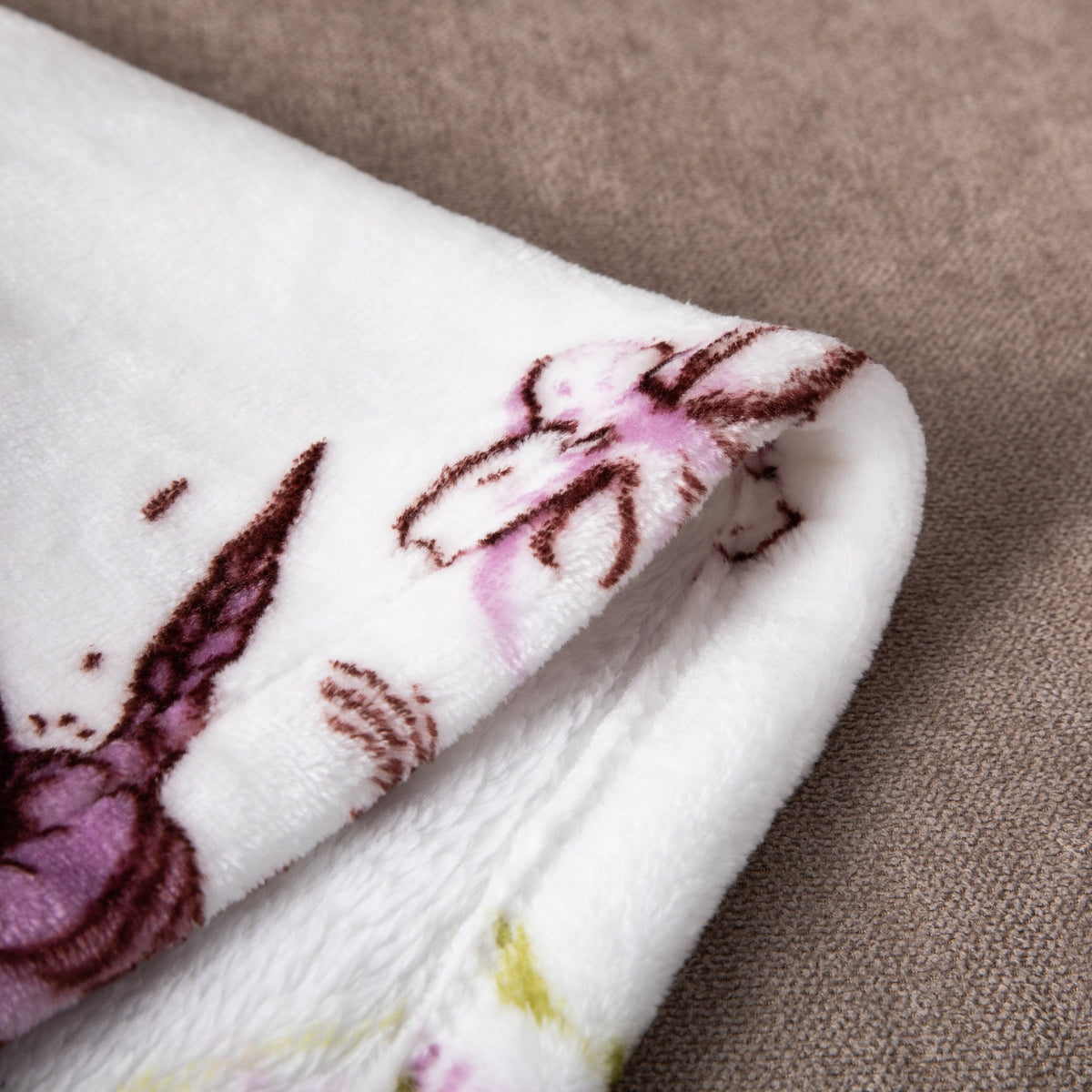 Floral blossoms and cottage birds on a soft flannel fleece throw blanket.