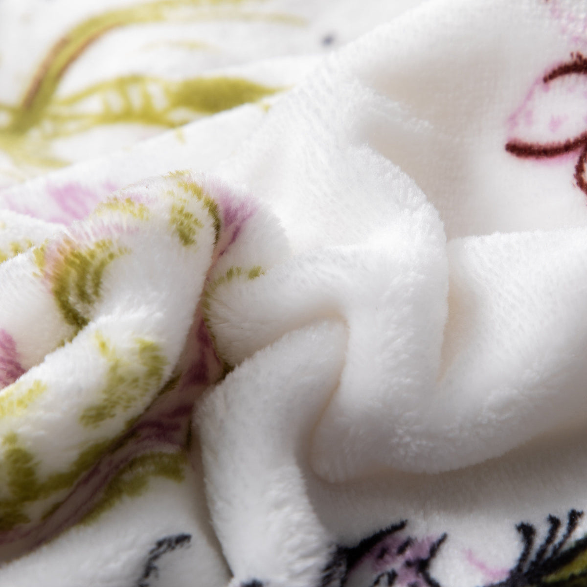 Flannel fleece throw blanket with floral blossoms and cottage birds pattern.