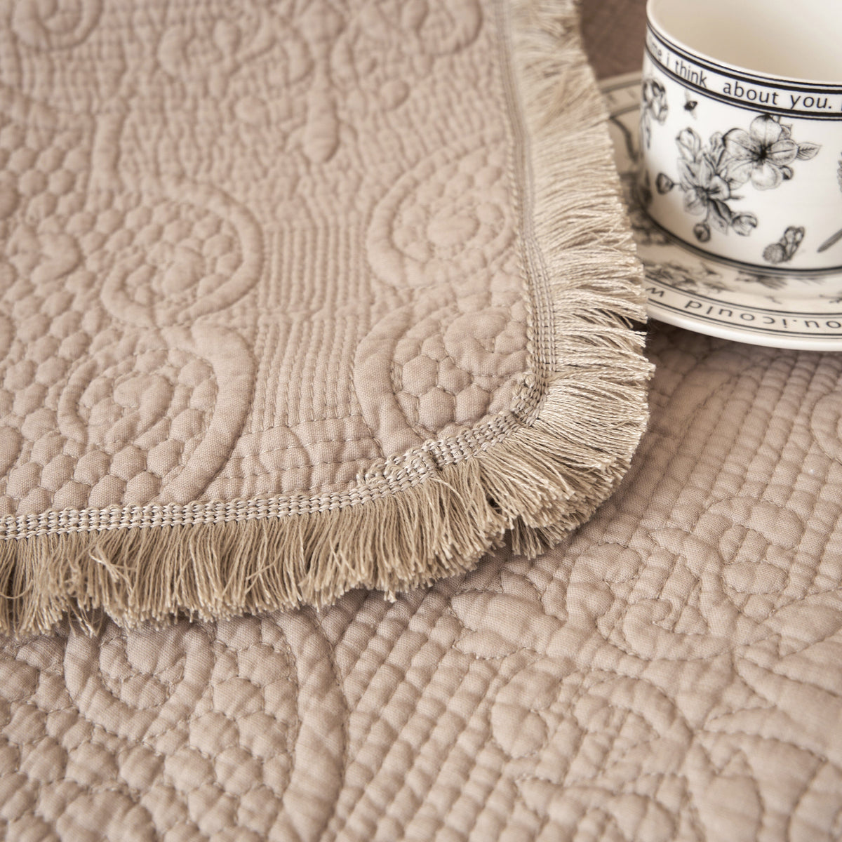 Elegant taupe beige 50x60 paisley quilted throw blanket with fringe.