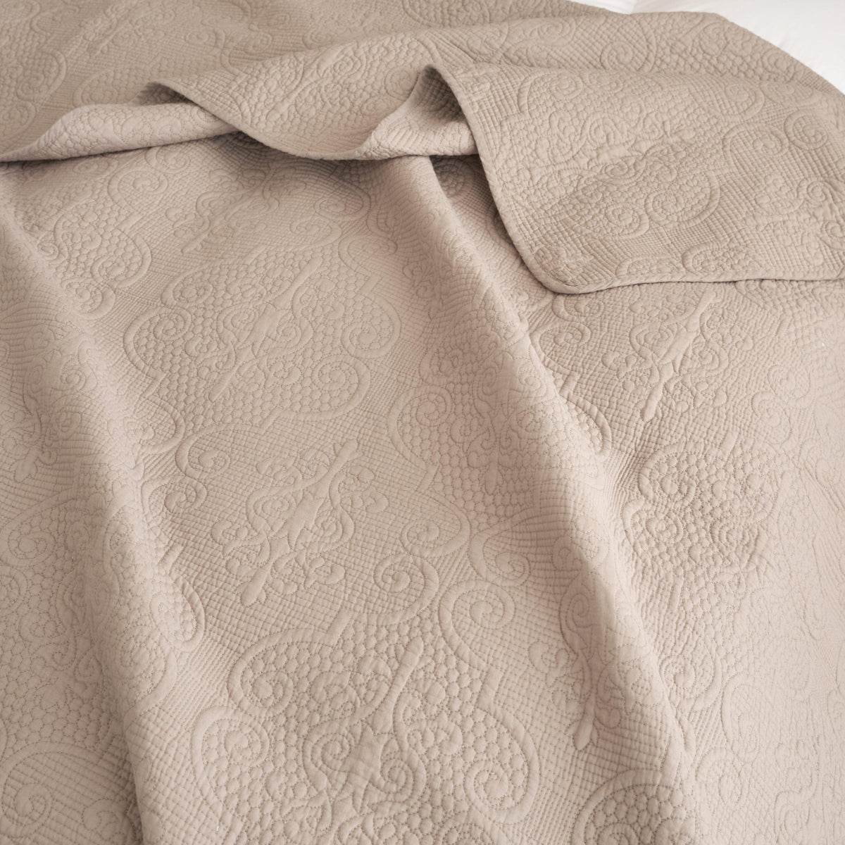 Taupe beige matelasse cotton quilted bedspread set with decorative stitching.