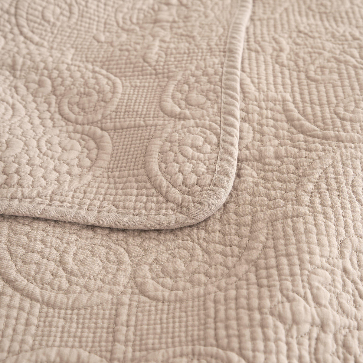 Taupe beige matelasse quilted bedspread set with pillow shams.