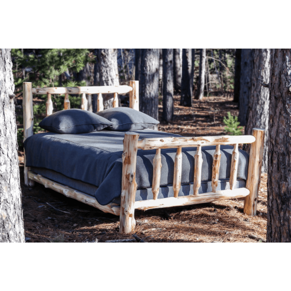 Rustic Dakota Unassembled Log Bed nestled in nature, perfect for cozy cabins and traditional decor.