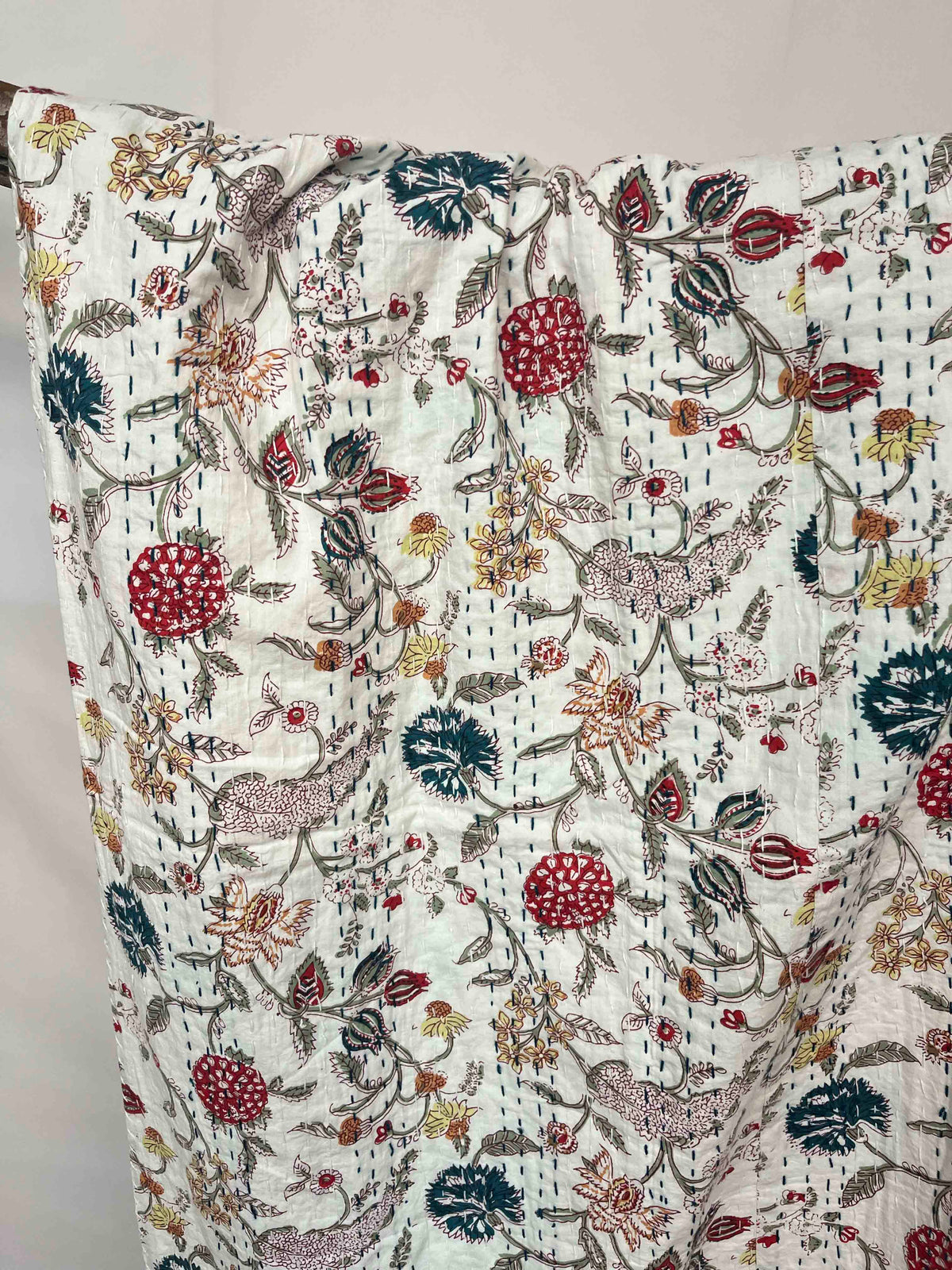 Kantha quilt bedspread with block print wildflower field pattern on cotton.