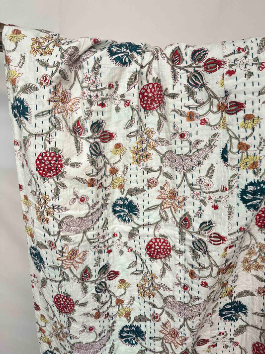 Kantha quilt bedspread with block print wildflower field pattern on cotton.
