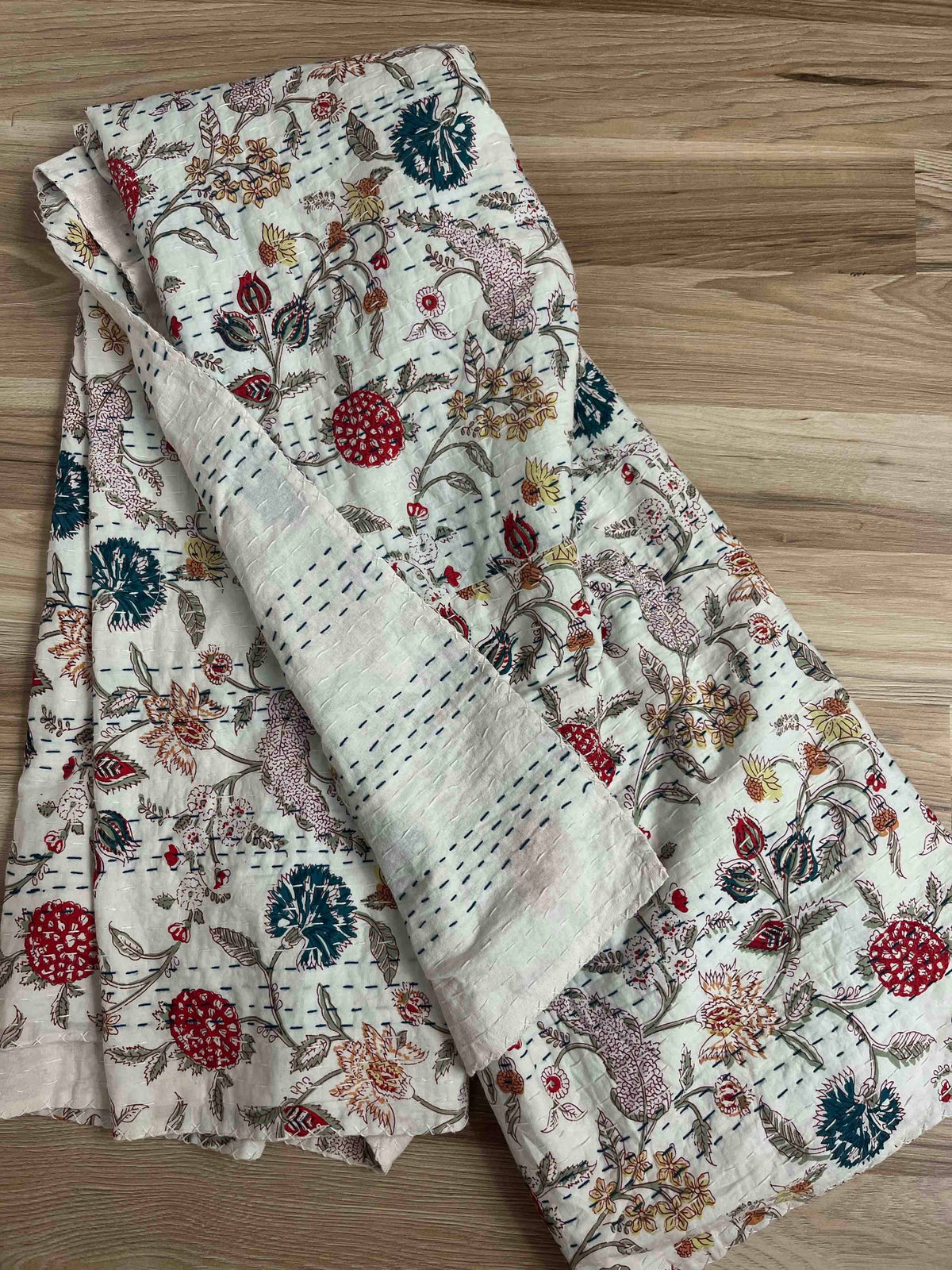 Block print cotton kantha quilt bedspread with a wildflower field design.