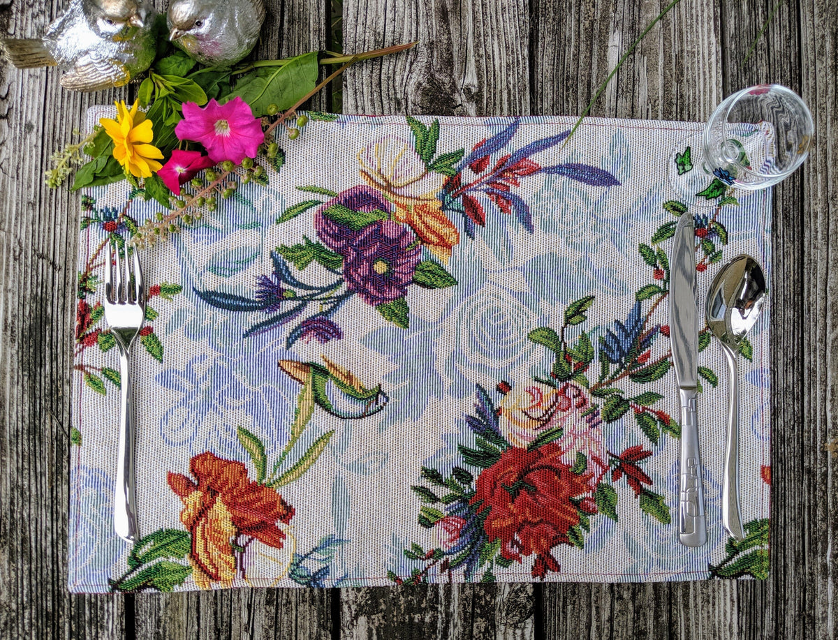 Four tropical sky blue bird and floral tapestry placemats, 13x19 inches.