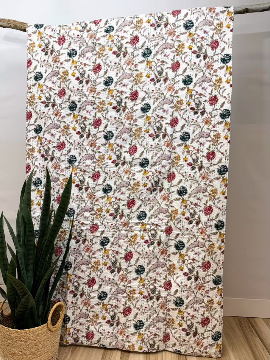 Wildflower field kantha quilt block print cotton bedspread with floral pattern.