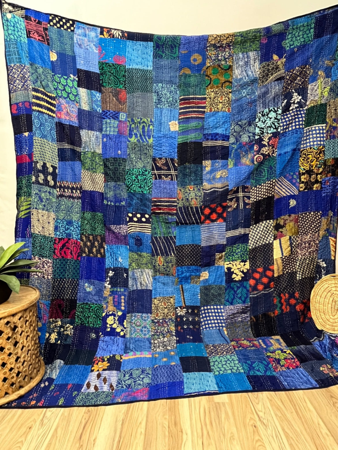 Pink patchwork silk Kantha quilt, hand-stitched by Indian artisans.