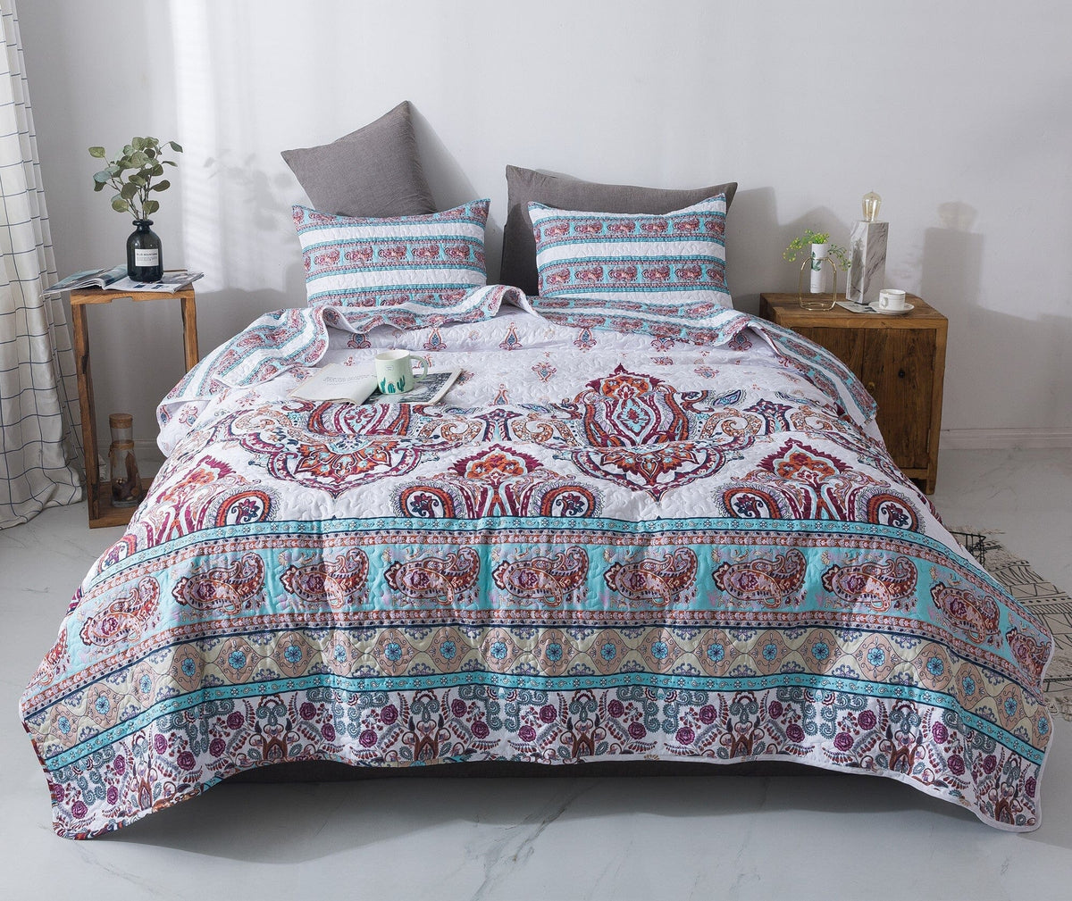 White and blue floral paisley bedspread set with pillow shams.