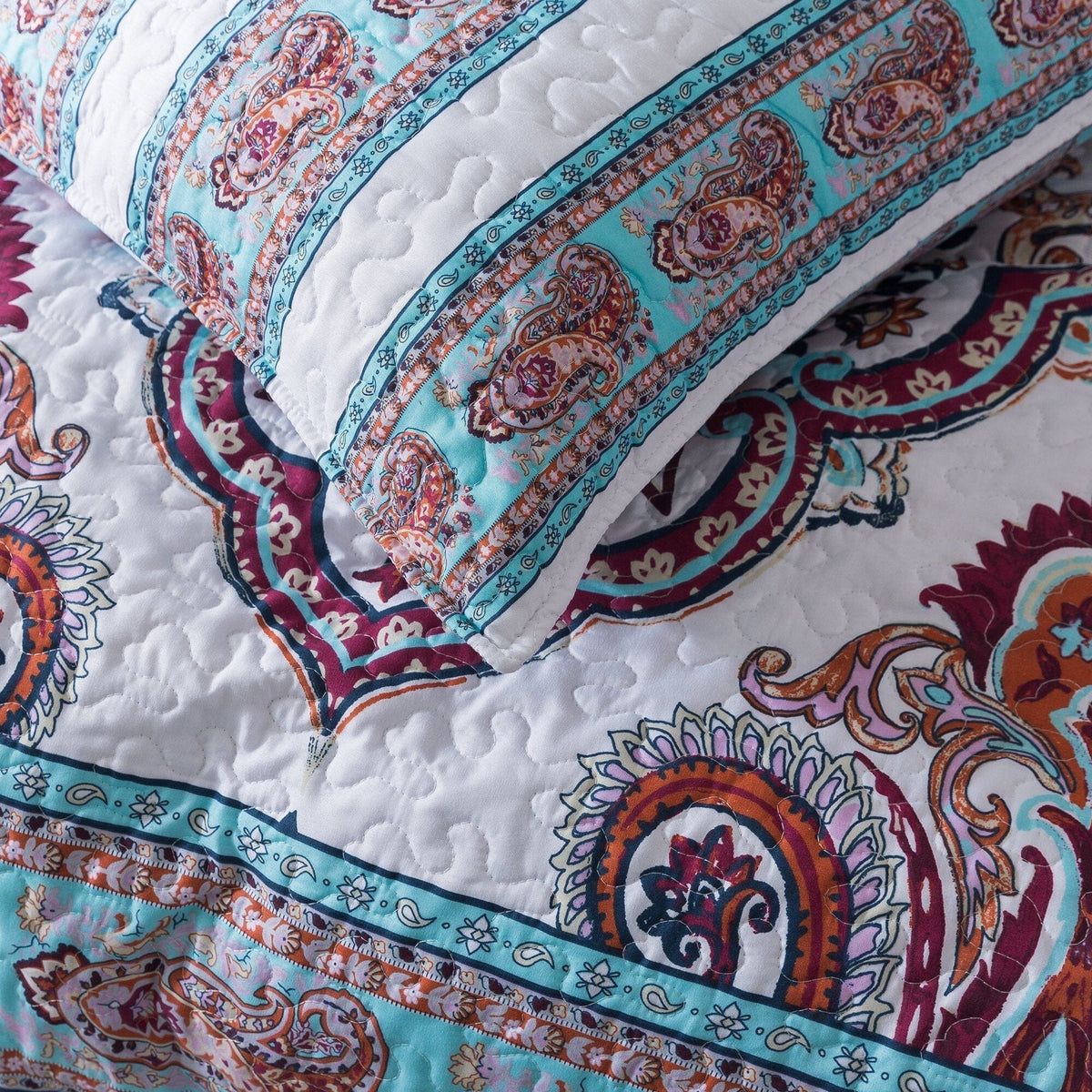 White and blue floral paisley bedspread set with matching shams.