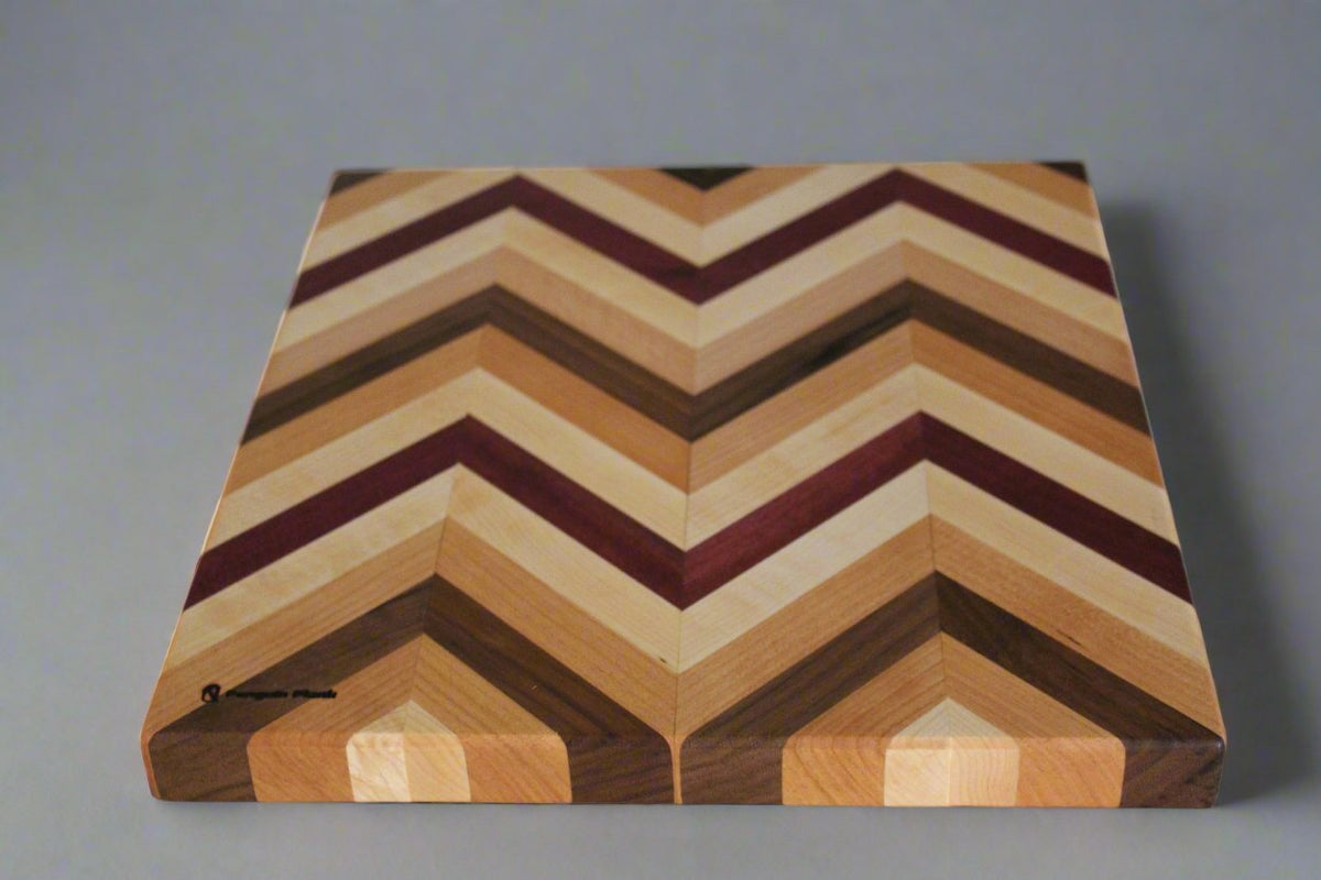 Herringbone cutting board with purpleheart, hard maple, walnut, and beech wood.