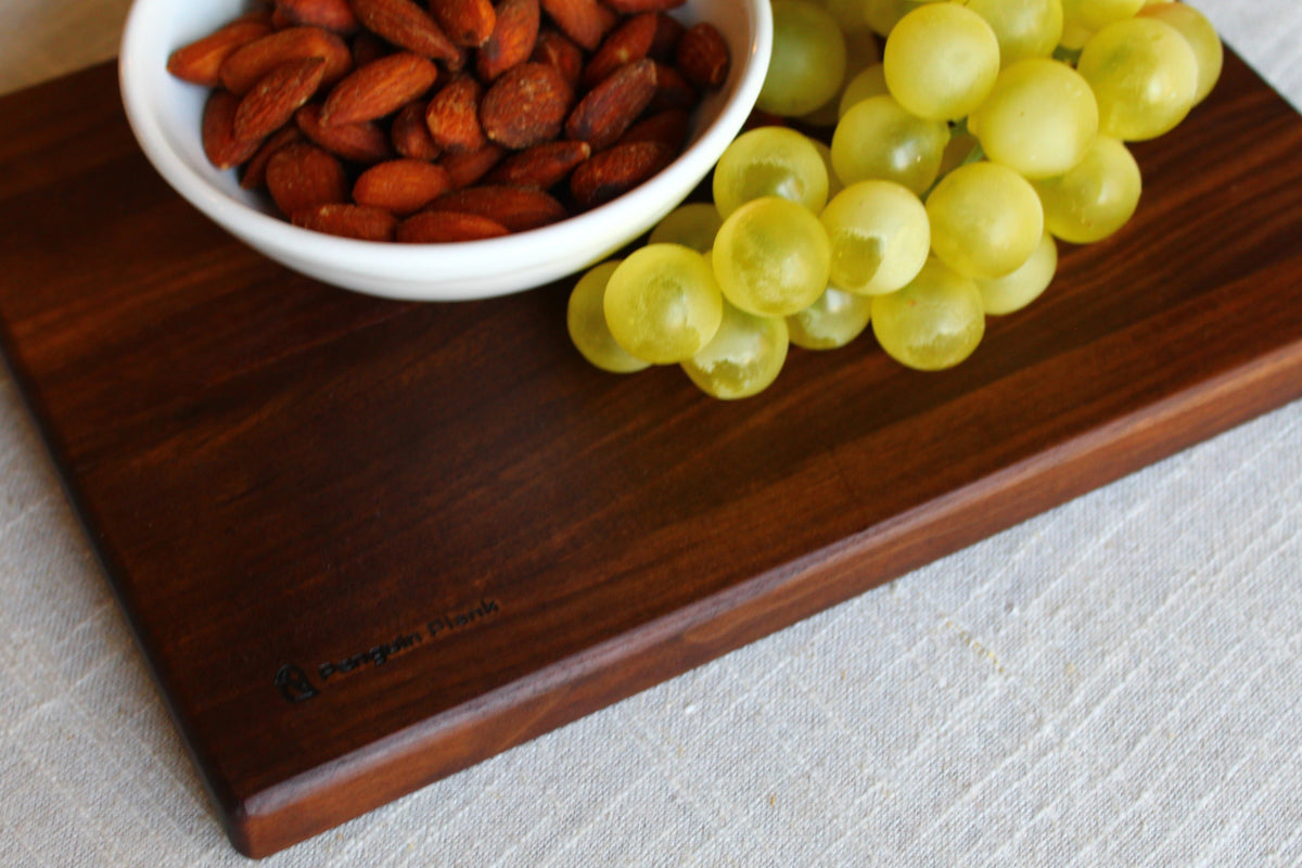 Walnut picnic cheese board with penguin handle.