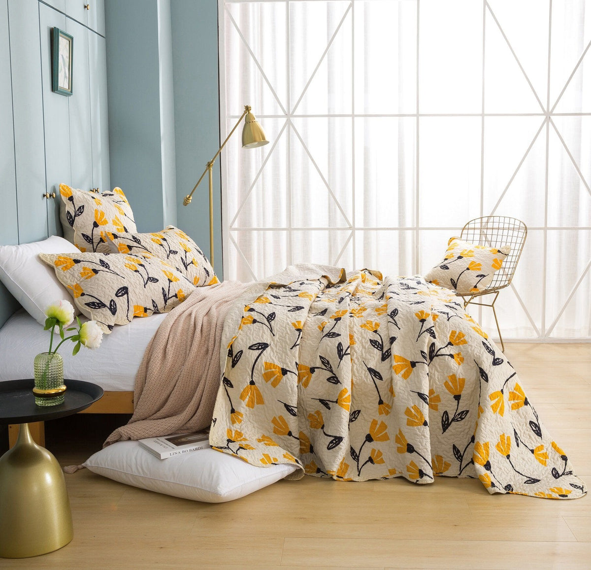 Yellow floral scalloped bedspread set on ivory cream background.