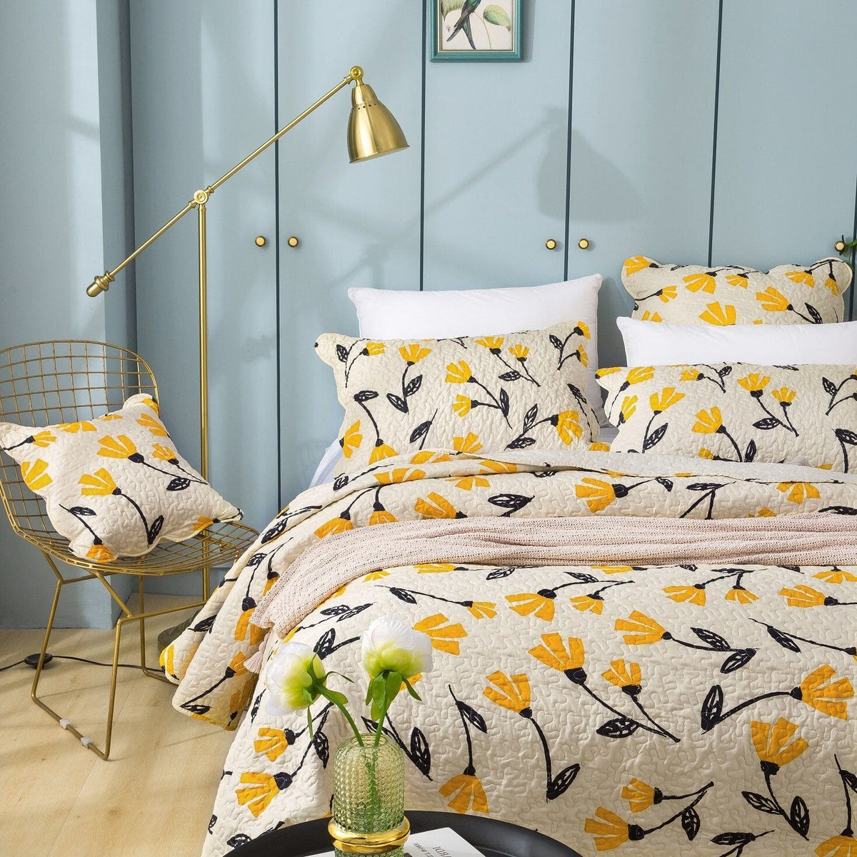 Yellow floral scalloped bedspread set on ivory cream background.