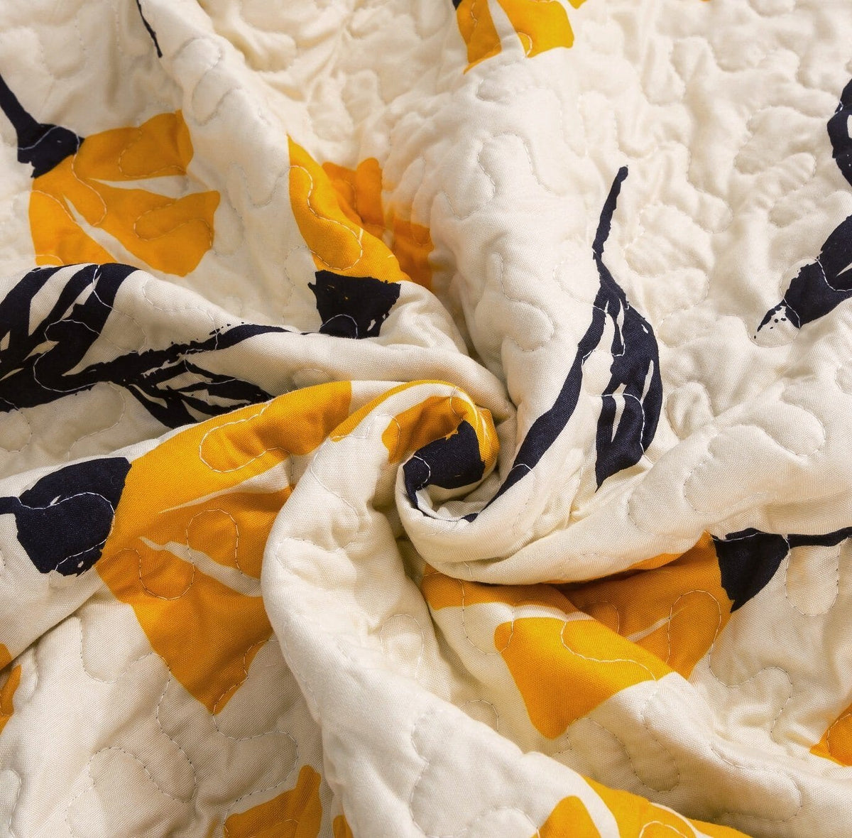 Yellow floral scalloped bedspread set on ivory cream background.