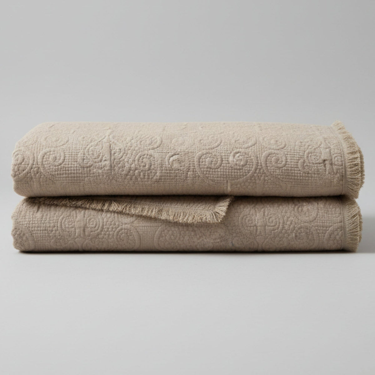 Elegant taupe beige 50x60 quilted throw blanket with paisley pattern and fringe detail.