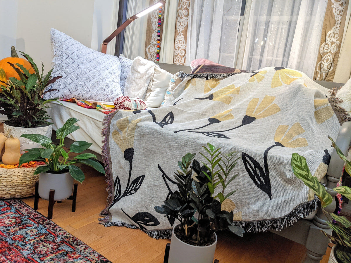 Yellow floral botanical throw blanket with golden floral tapestry design, 50x60 inches.