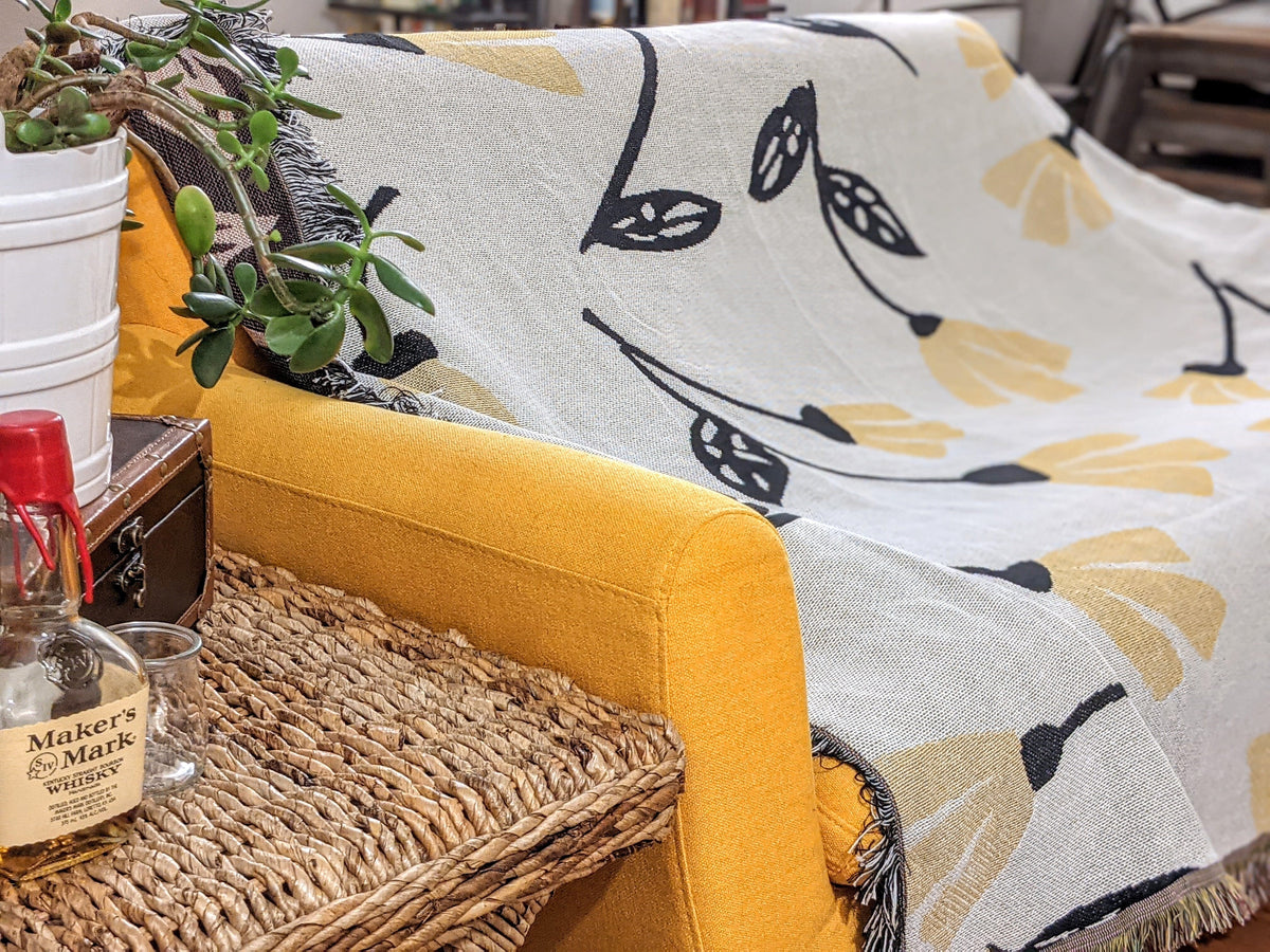 Yellow floral tapestry throw blanket with golden botanical pattern, 50x60 inches.