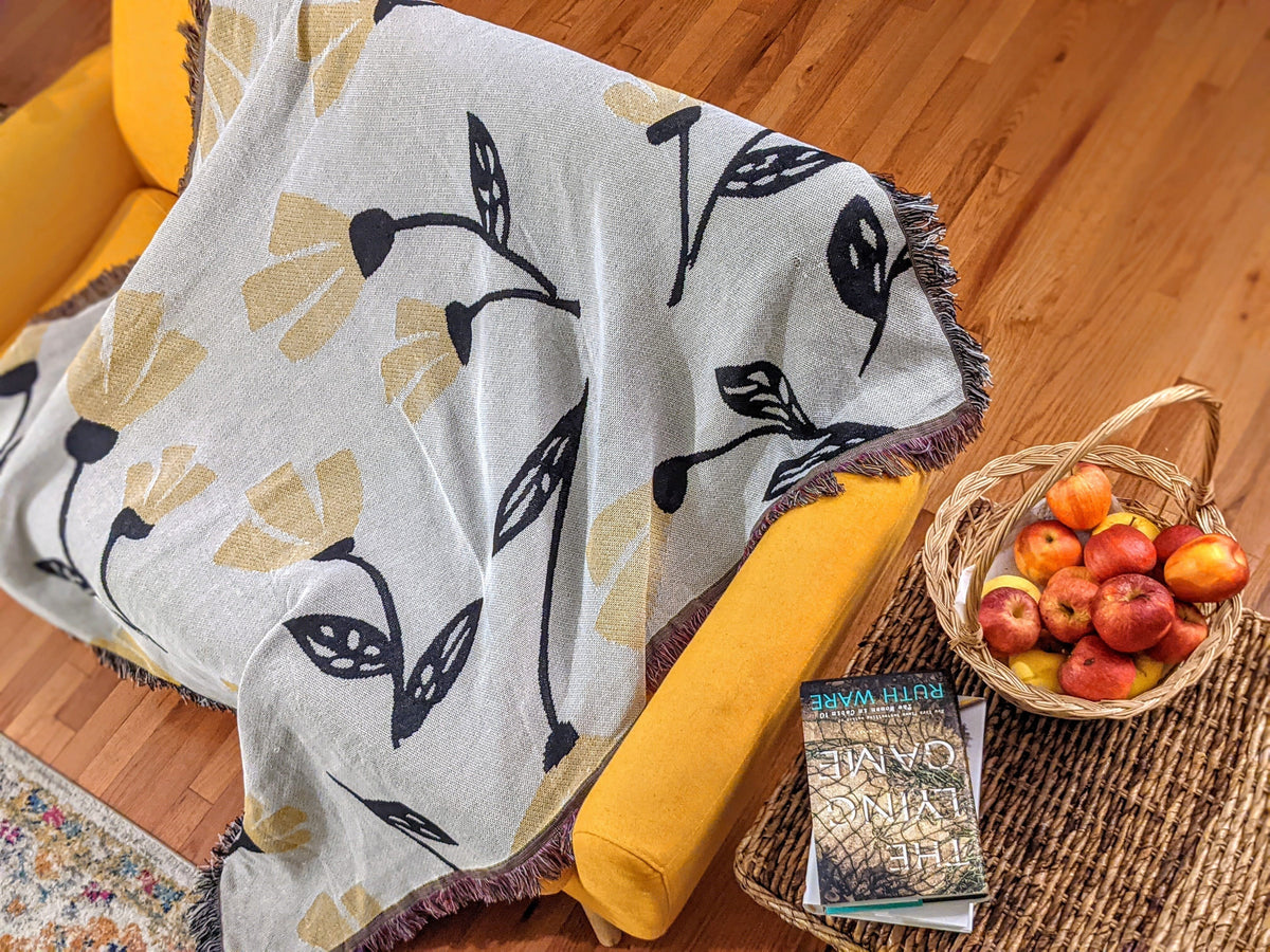 Yellow floral tapestry throw blanket, 50x60 inches, featuring golden botanical print.