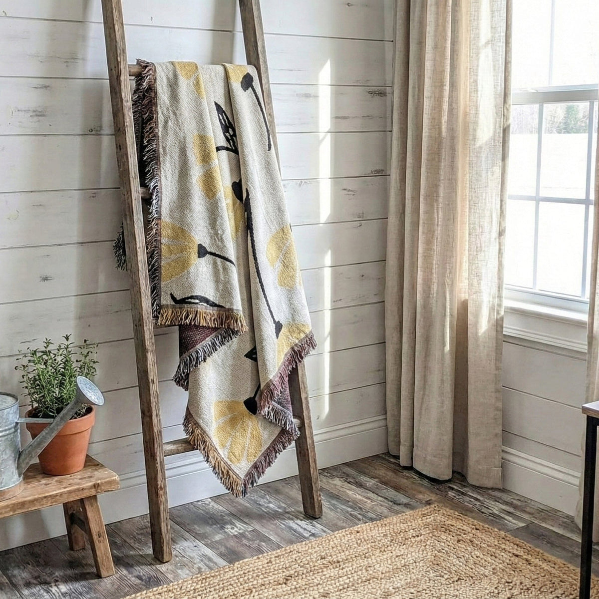Yellow floral tapestry throw blanket with golden botanical pattern.