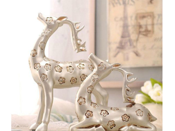 Elegant silver deer sculptures with antlers, a pair.