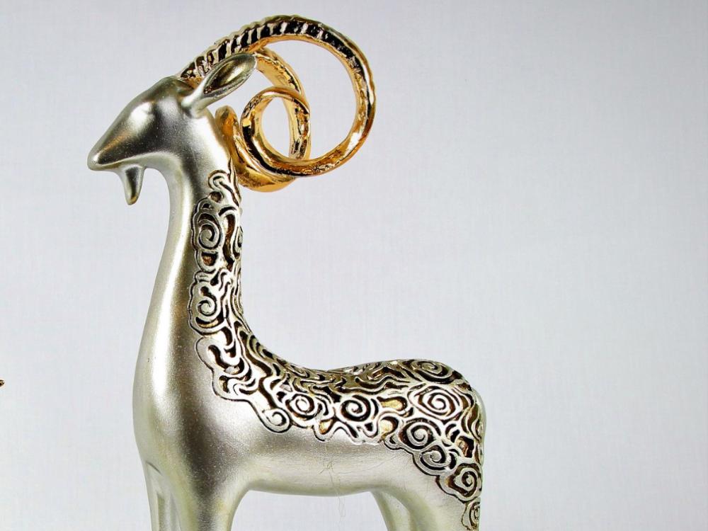 Three resin bighorn sheep sculptures with golden horns, family decor.
