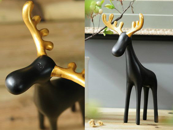 Three black resin reindeer sculptures with gold antlers, a family of three table decor.