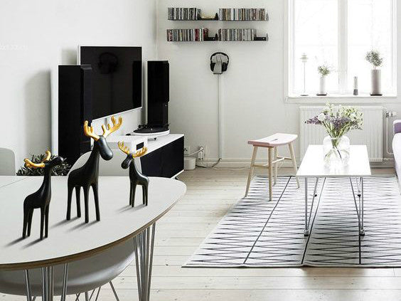 Three black resin reindeer sculptures with gold antlers, family of three.