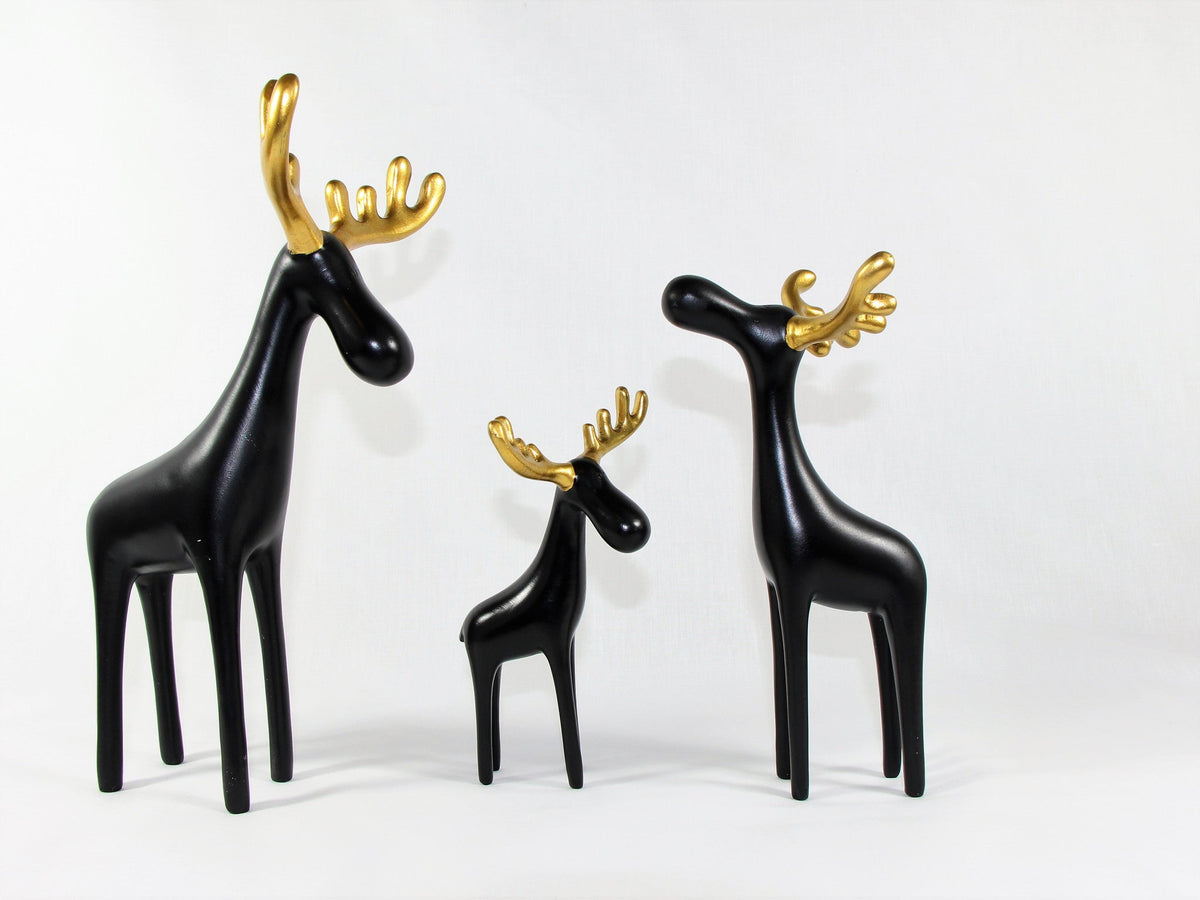 Three black reindeer sculptures with gold antlers, resin table decor