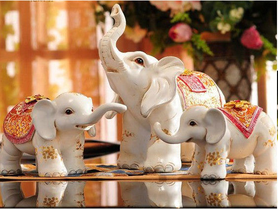 Three red jewel-covered Maharaja elephant sculptures decor set.