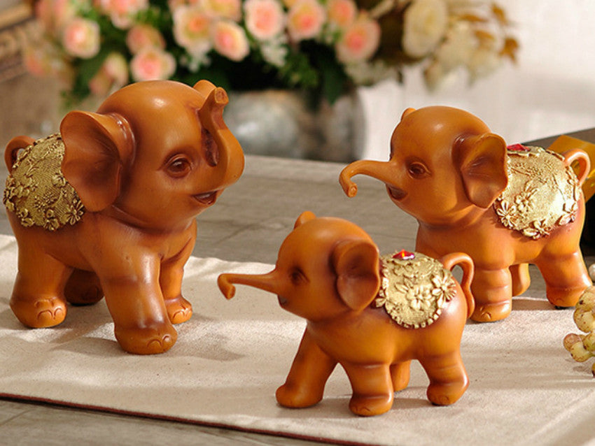Brown resin elephant family of three figurines for home decor.
