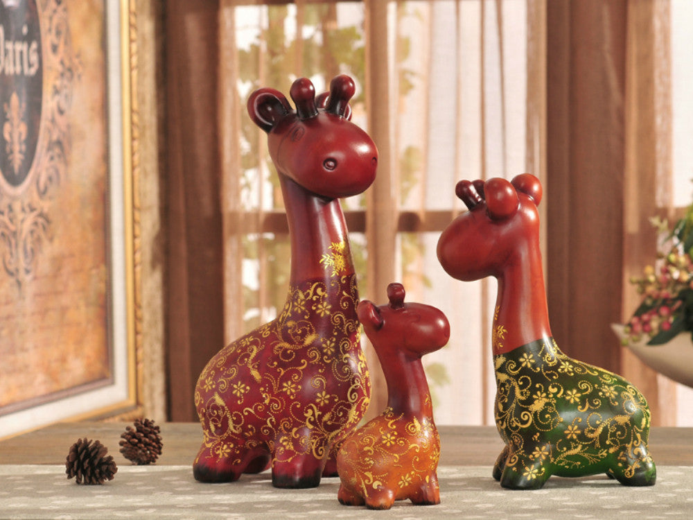 Hand-painted resin sculpture set of a colorful giraffe family for table decor.