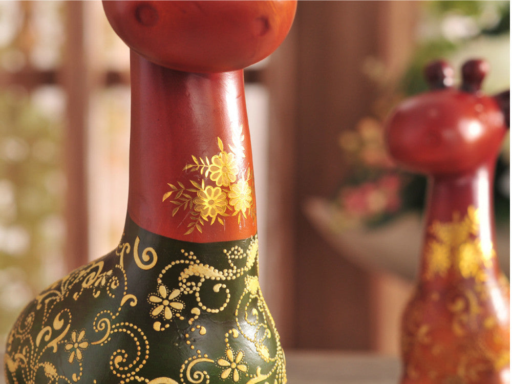 Hand-painted resin sculpture set of a colorful giraffe family for table decor.