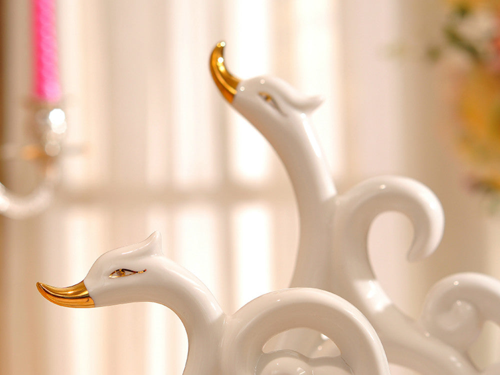 White porcelain swans with decorative wings for elegant table decor