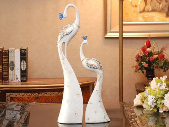 Pair of hand-painted white and blue peacock sculptures for table decor.