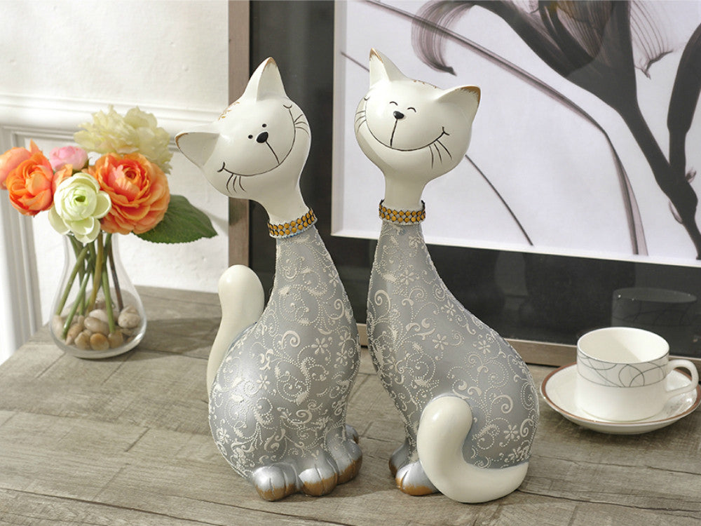 Pair of silver resin cat statues for table decor.