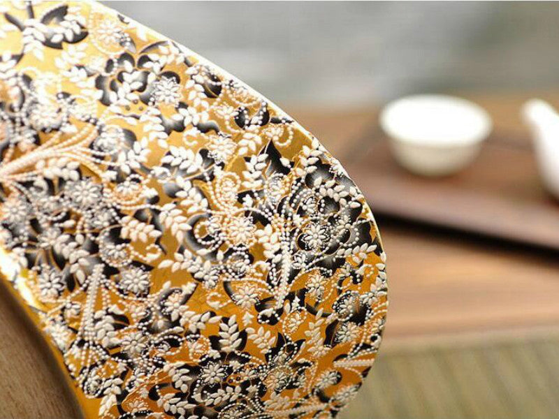 Antique brown resin broad vase with vintage floral decor texture.