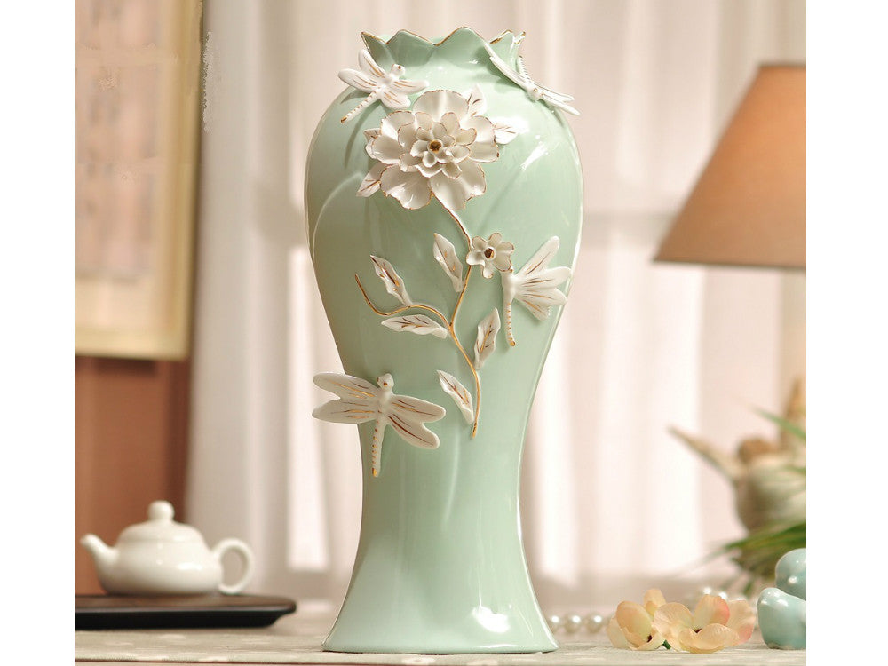 Aqua green porcelain vase with delicate pinched white flowers.