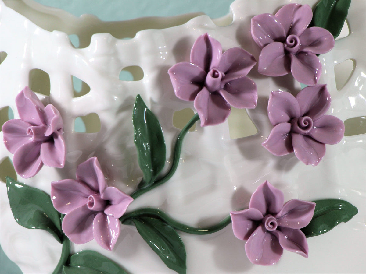 Wide mouth porcelain vase with realistic purple flowers