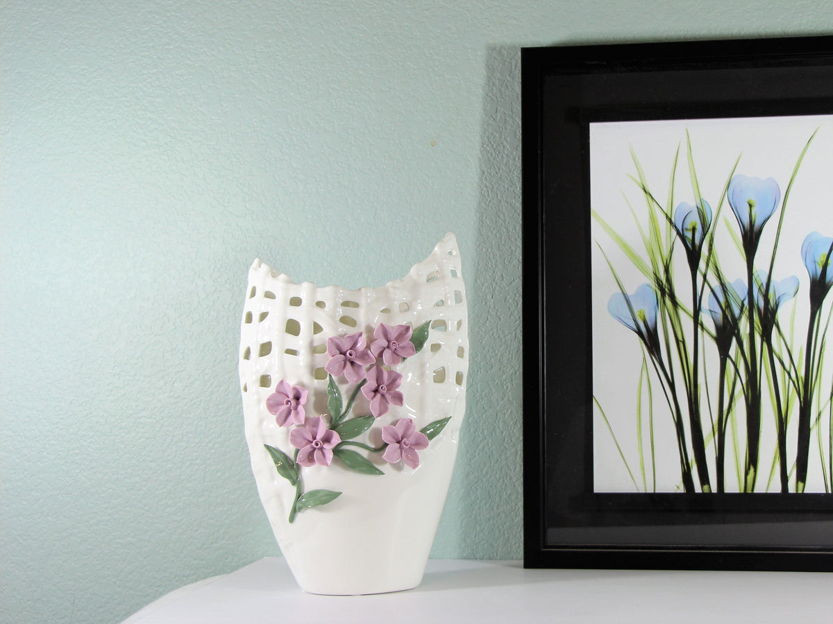 Tall white porcelain vase with pinched purple flowers