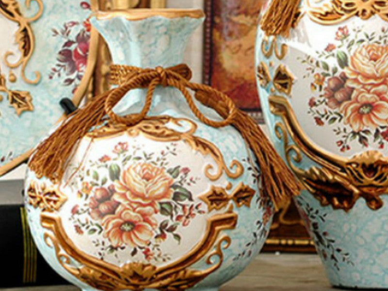 Light blue ceramic vase set with floral design and gold rim