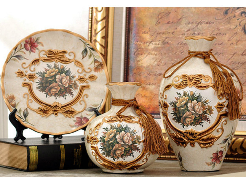Three light brown ceramic vases with gold rims and tassels, Royal Collection.
