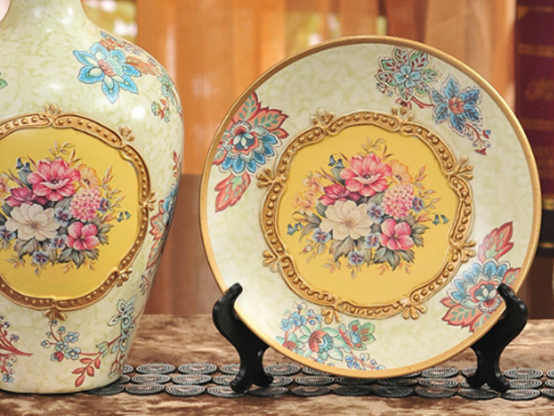 Three yellow vintage ceramic vases with gold bands and floral designs.