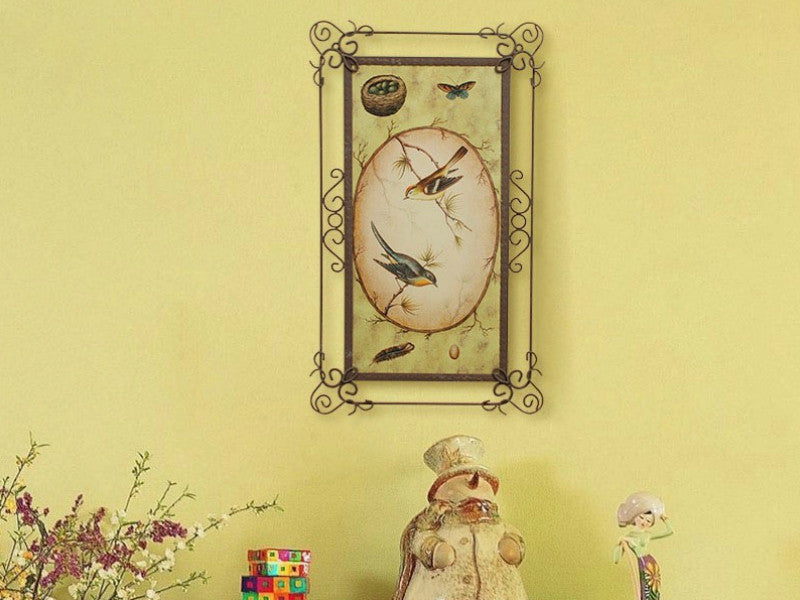 Two blue and yellow metal lovebirds wall art pieces.